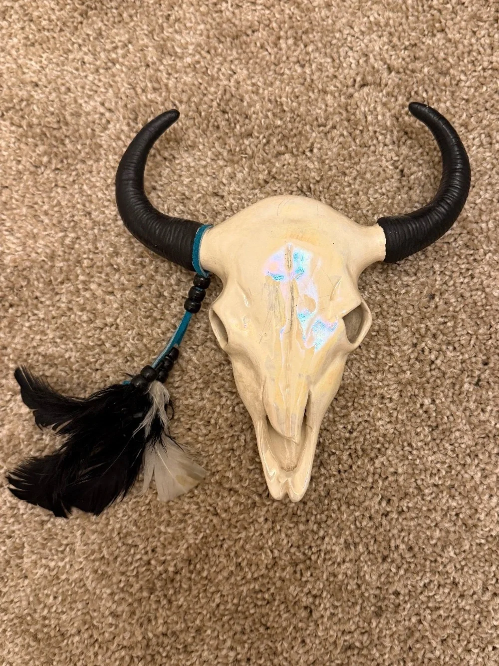 Porcelain glazed faux skull with leather and beaded feathers